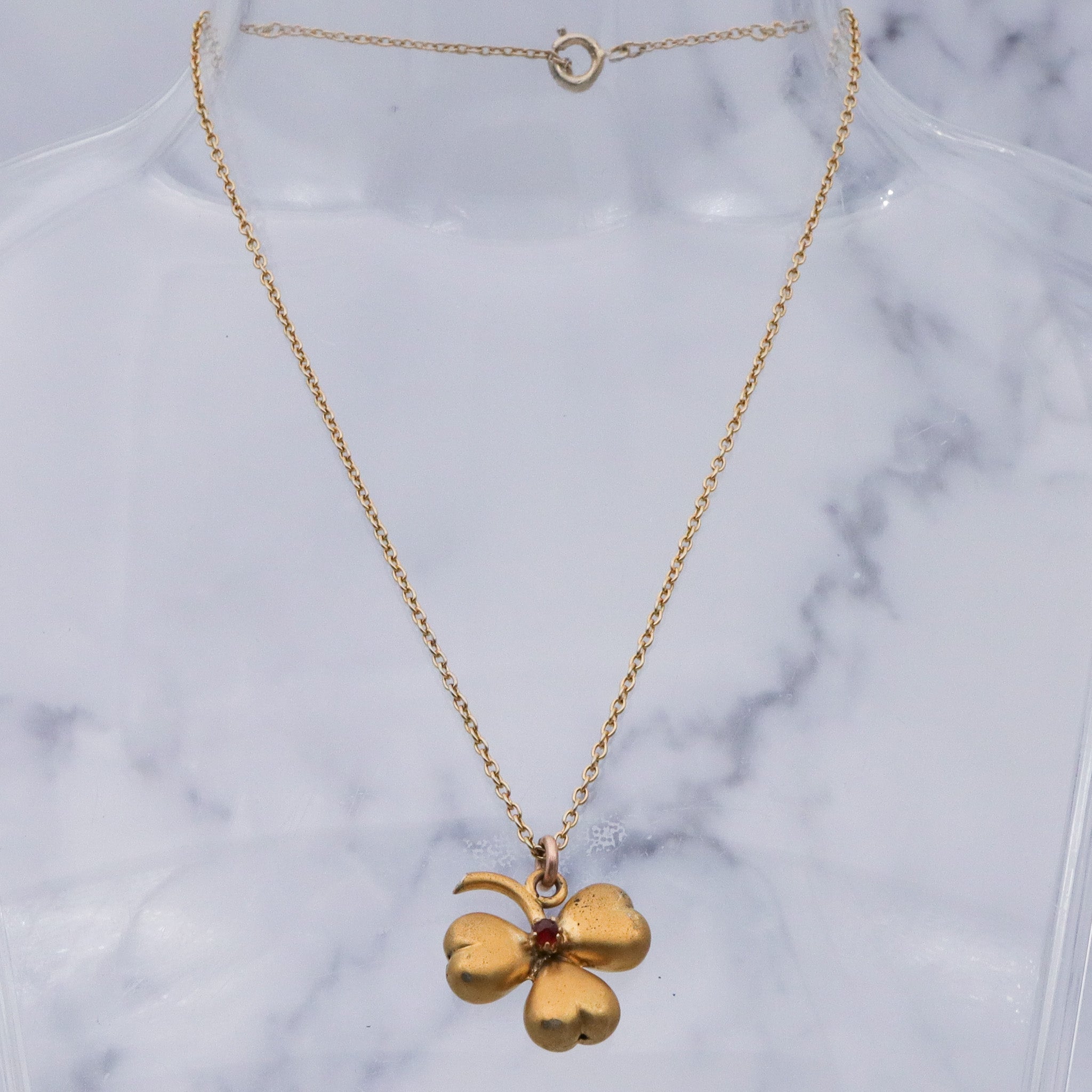 Antique Victorian gilt metal clover with faux garnet pendant